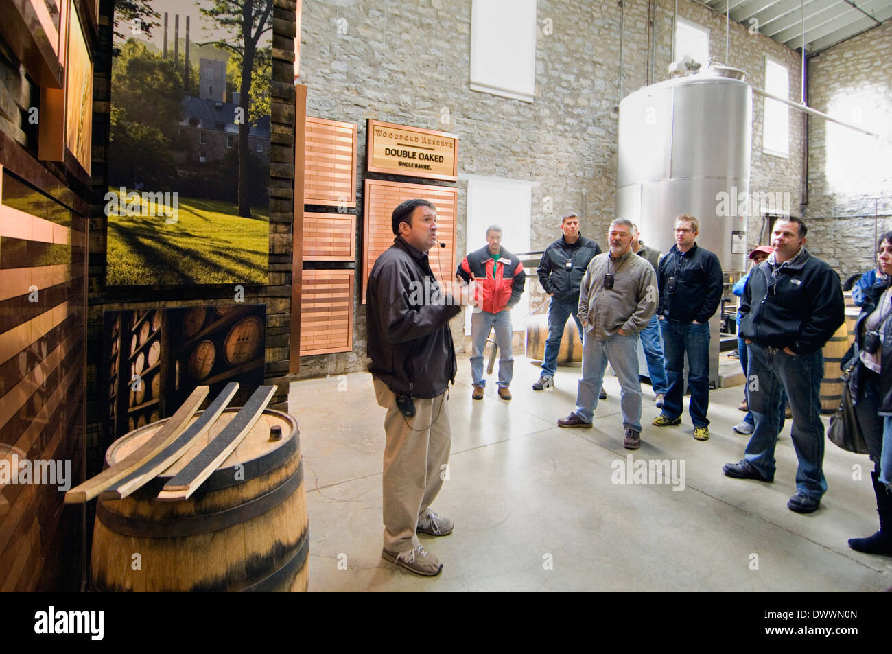 Tour Guide Explaining the Charred White Oak Barrels used to Age Bourbon at Woodford Reserve Distillery in Kentucky Stock Photo