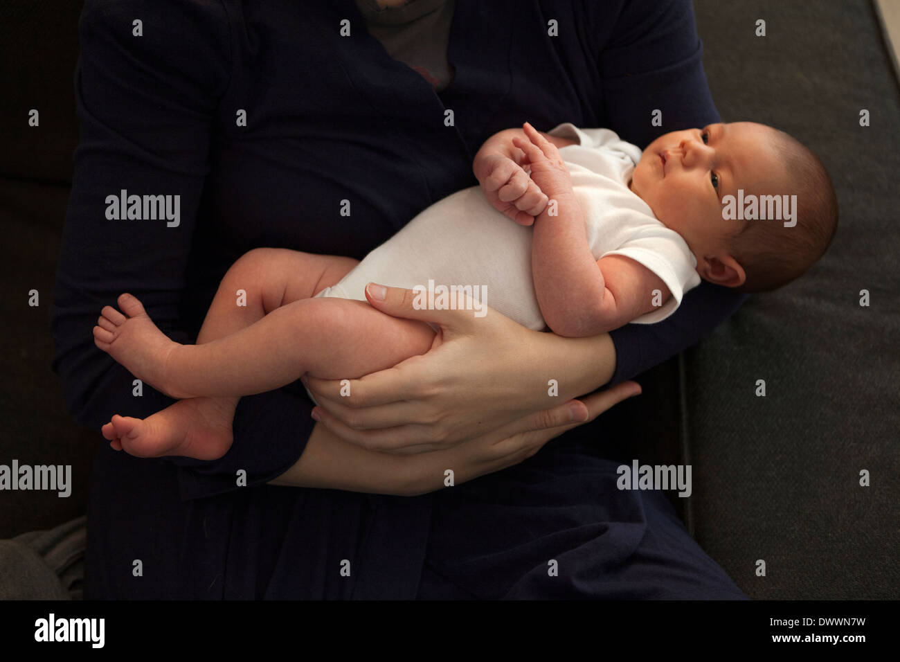 3week old baby in her mother's arms. Photo by Worne Stock Photo