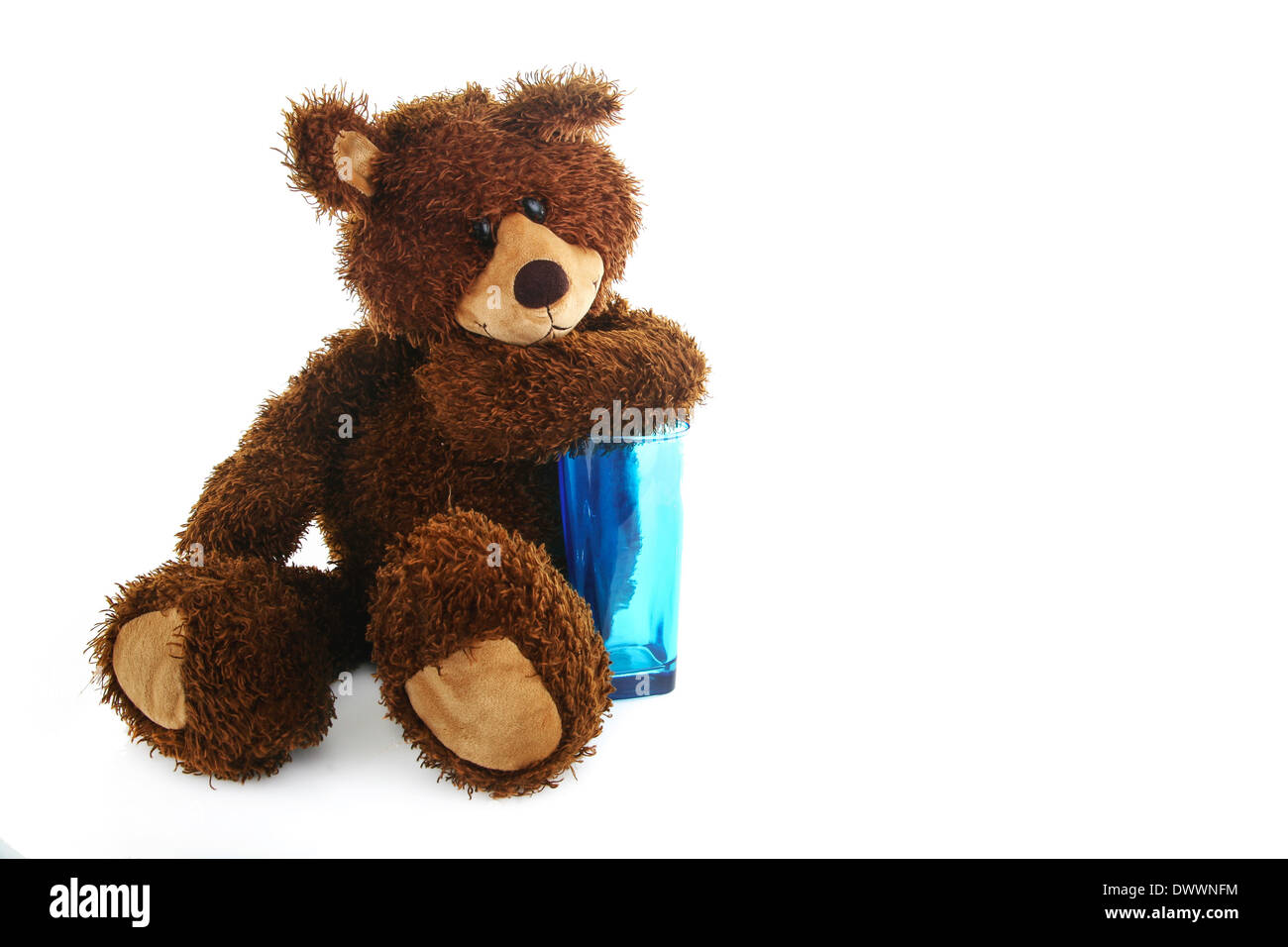 Teddy bear with a blue transparent glass Stock Photo