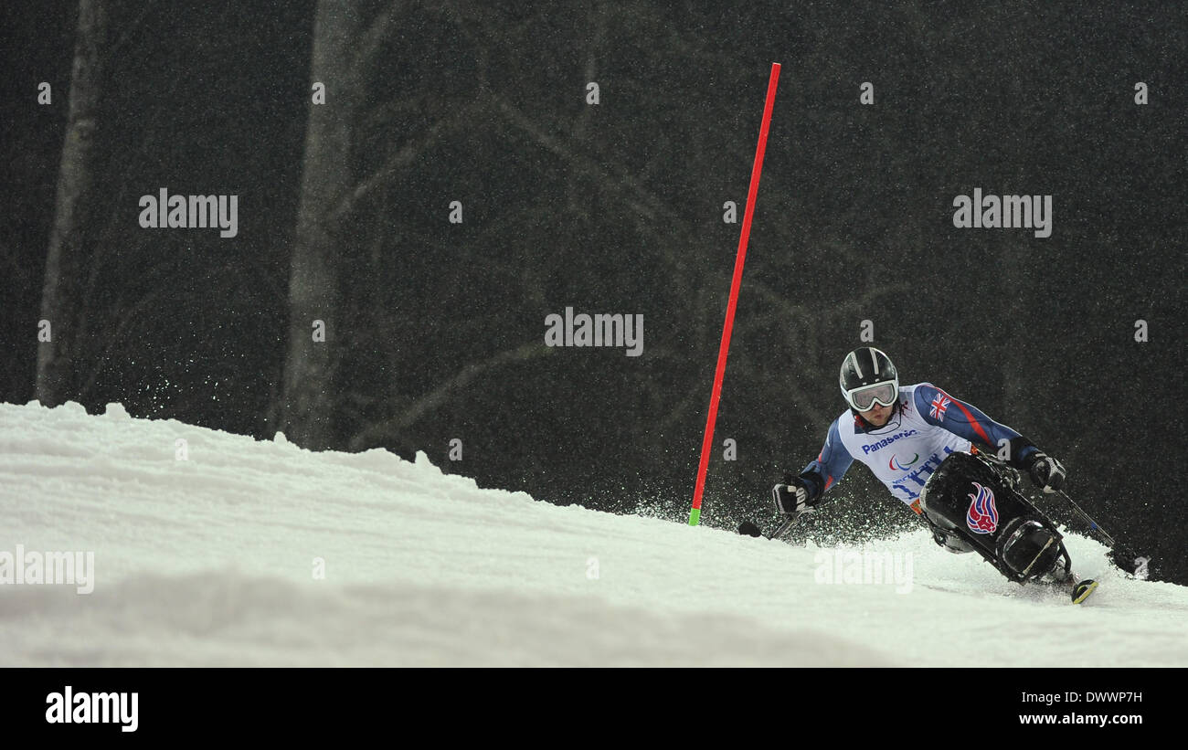 Sochi, Russia. 13th Mar, 2014. Ben Sneesby of Great Britain competes during the alpine skiing men's slalom 2nd run - sitting competition at the 2014 Paralympic Winter Games in Sochi, Russia on March 13, 2014. Credit: Dai Tianfang/Xinhua/Alamy Live News Stock Photo