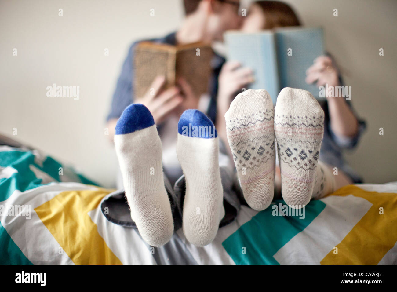 USA, Massachusetts, Young couple kissing on bed, focus on feet Stock Photo