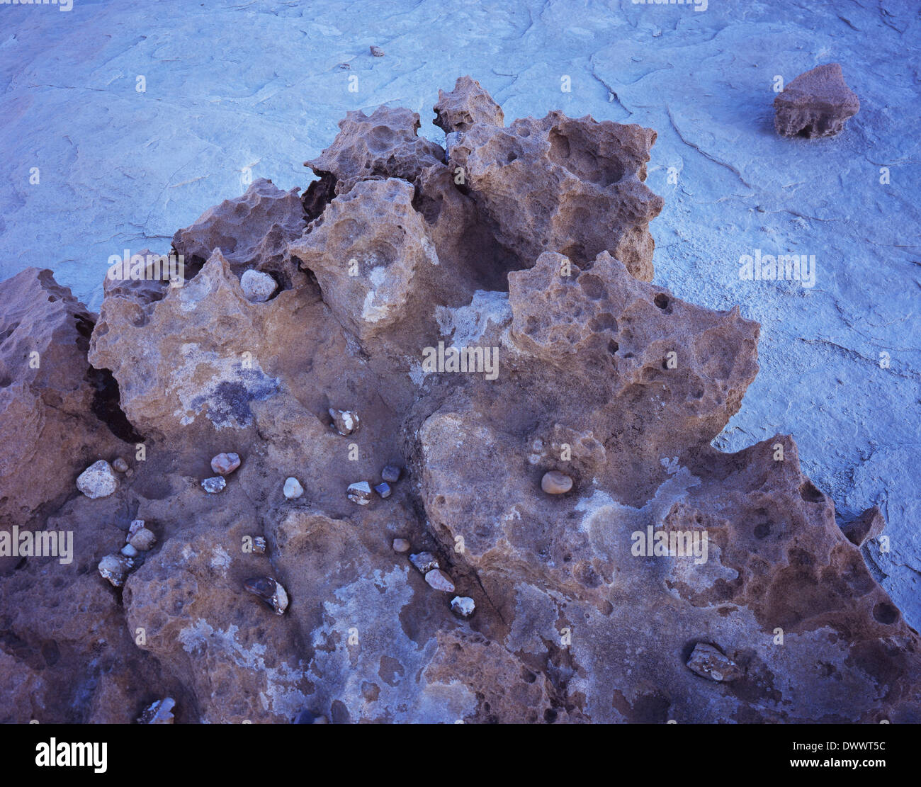 Pebbles in Eroded Rock Stock Photo - Alamy
