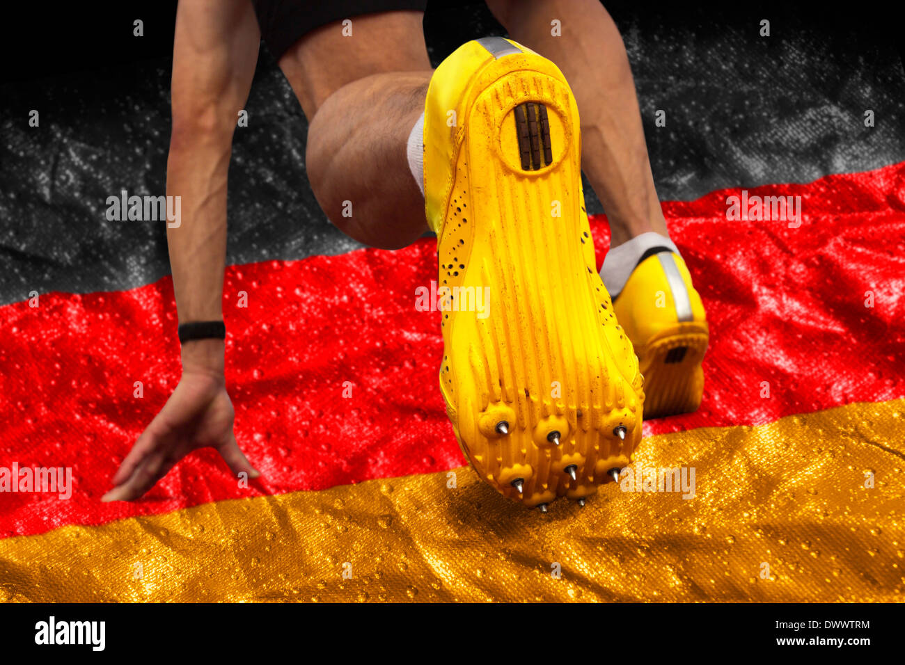 Sprinter starts on banner with German national colors Stock Photo