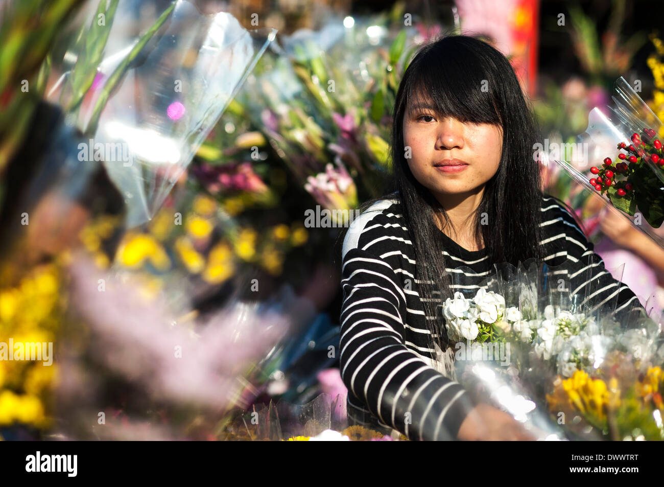 Young girl selling flowers at the new year flower market, Victoria Park