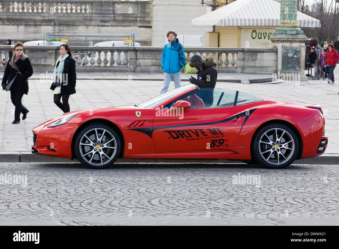 Man Stood by a Ferrari with Drove me on the side in the Place de la Concorde Paris France Stock Photo