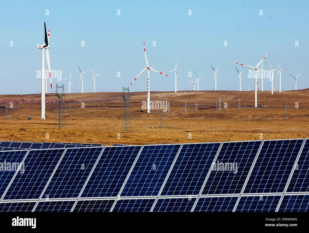 Zhangjiakou. 14th Mar, 2014. Photo taken on March 14, 2014 shows the photovoltaic (PV) and wind power plants in Bashang region in Zhangjiakou, north China's Hebei Province. China's on-grid wind power generation capacity will hit 90 million kilowatts (kw) at the end of 2014, from 77.16 million kws in 2013, the National Energy Administration (NEA) said recently. © Yang Shiyao/Xinhua/Alamy Live News Stock Photo