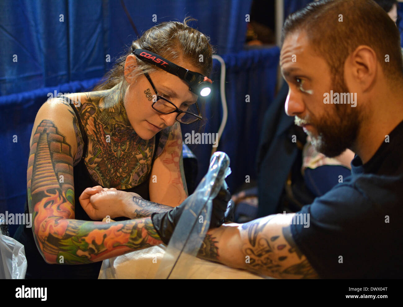 Man getting a forearm tattoo at the New York Tattoo convention in Manhattan at the Roseland Ballroom in New York City Stock Photo