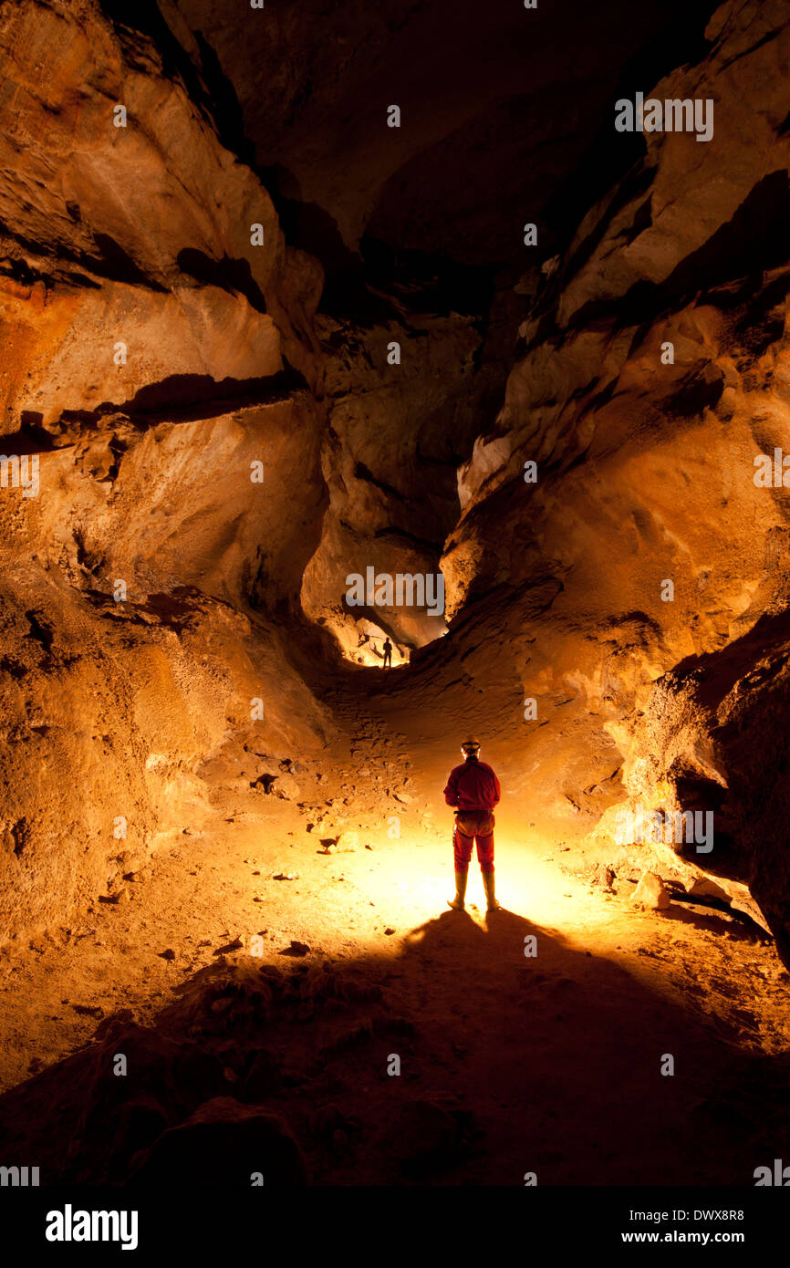 Cavers in a large passage in Cueva Coventosa, Cantabria, northern Spain Stock Photo