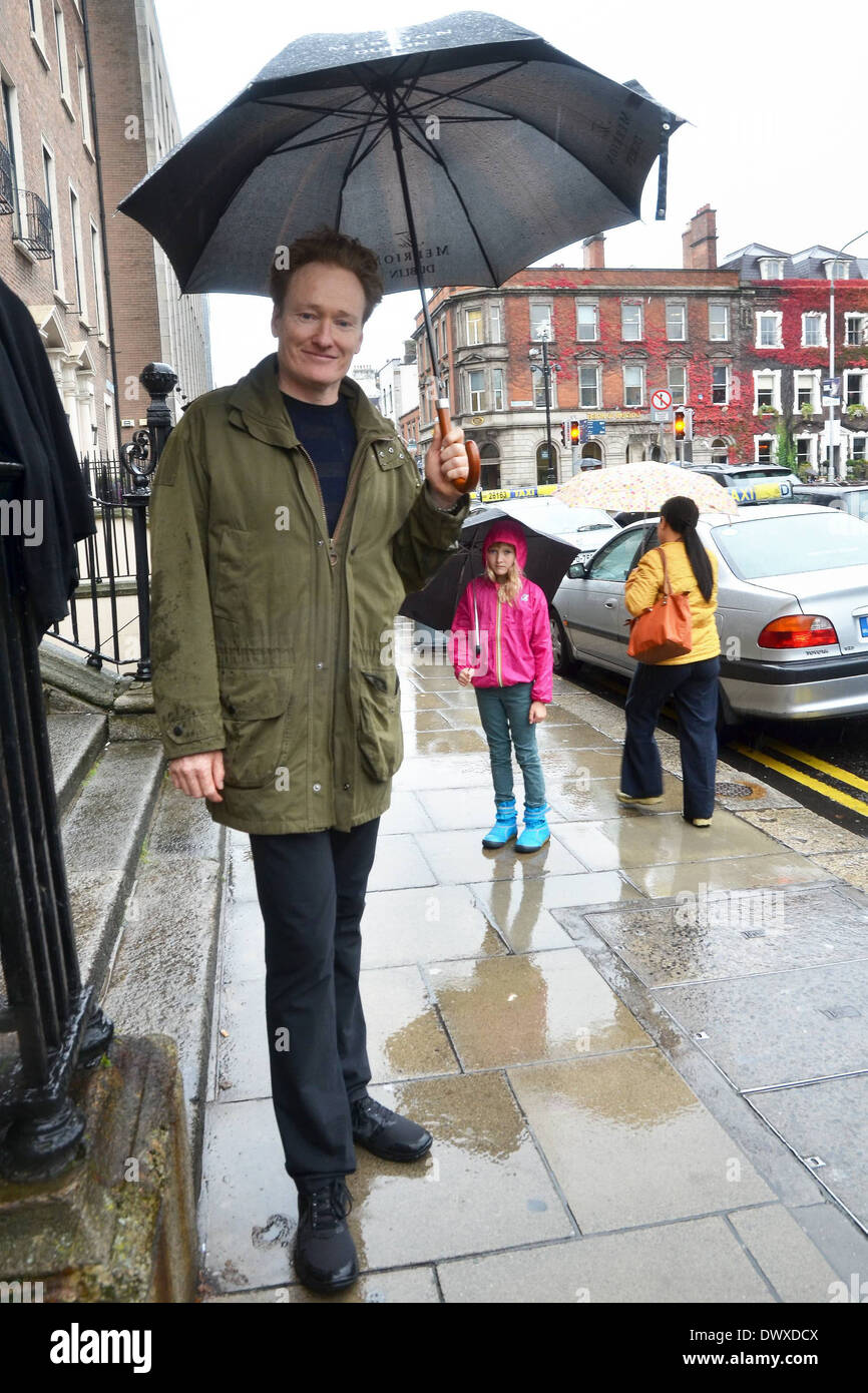 Conan O'Brien and his daughter Neve spotted walking in the rain under umbrellas on St Stephens