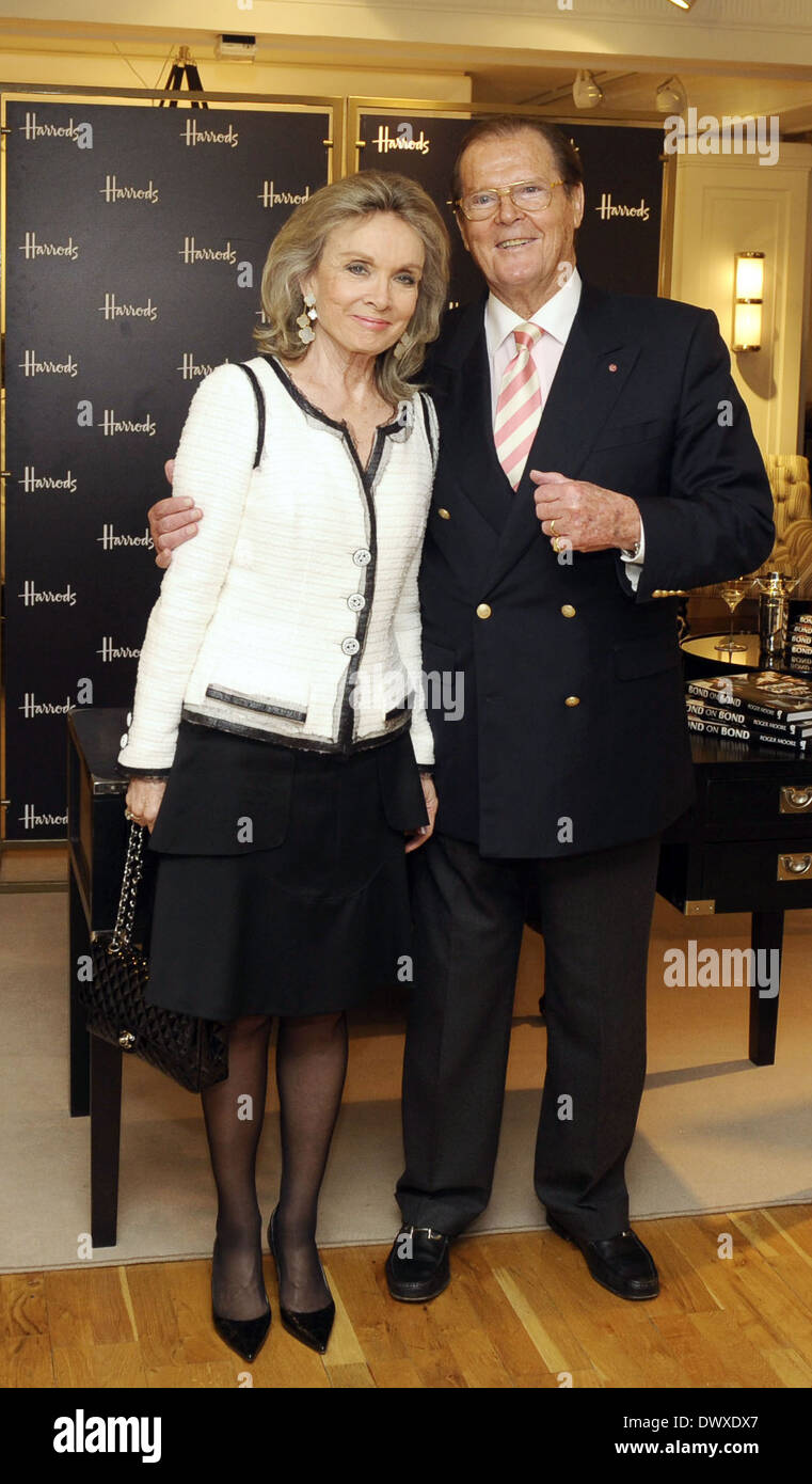 Sir Roger Moore with his wife, Kristina Tholstrup as he signs copies of his book entitled 'Bond on Bond' at Harrods in Knightsbridge London, England - 11.10.12 Featuring: Sir Roger Moore with his wife, Kristina Tholstrup Where: London, United Kingdom When Stock Photo