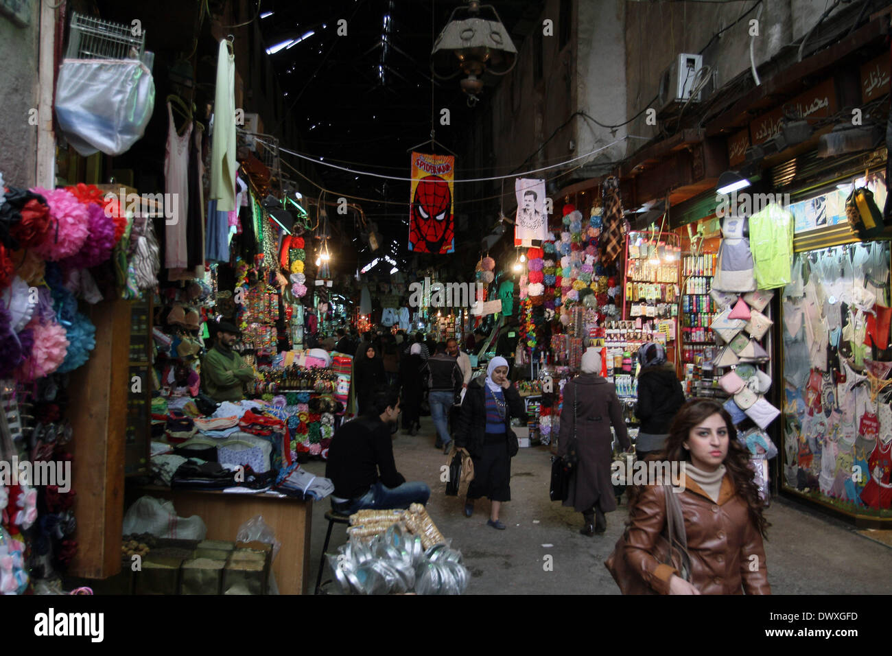 Damascus, Syria. 13th Mar, 2014. People walk in al-Hamidiyah Souk, one of the largest marketplaces in Syria, in the old city of Damascus, Syria, March 13, 2014. Despite the crunching crisis in Syria, which is entering its fourth year, and the economic hardship that ensued, Syrians in the capital Damascus haven't abandoned their popular markets even though most of them have become window shoppers as their purchasing capabilities have dramatically dropped due to the depreciation of the Syrian pound, the high unemployment rates and the western sanctions. © Bassem Tellawi/Xinhua/Alamy Live News Stock Photo