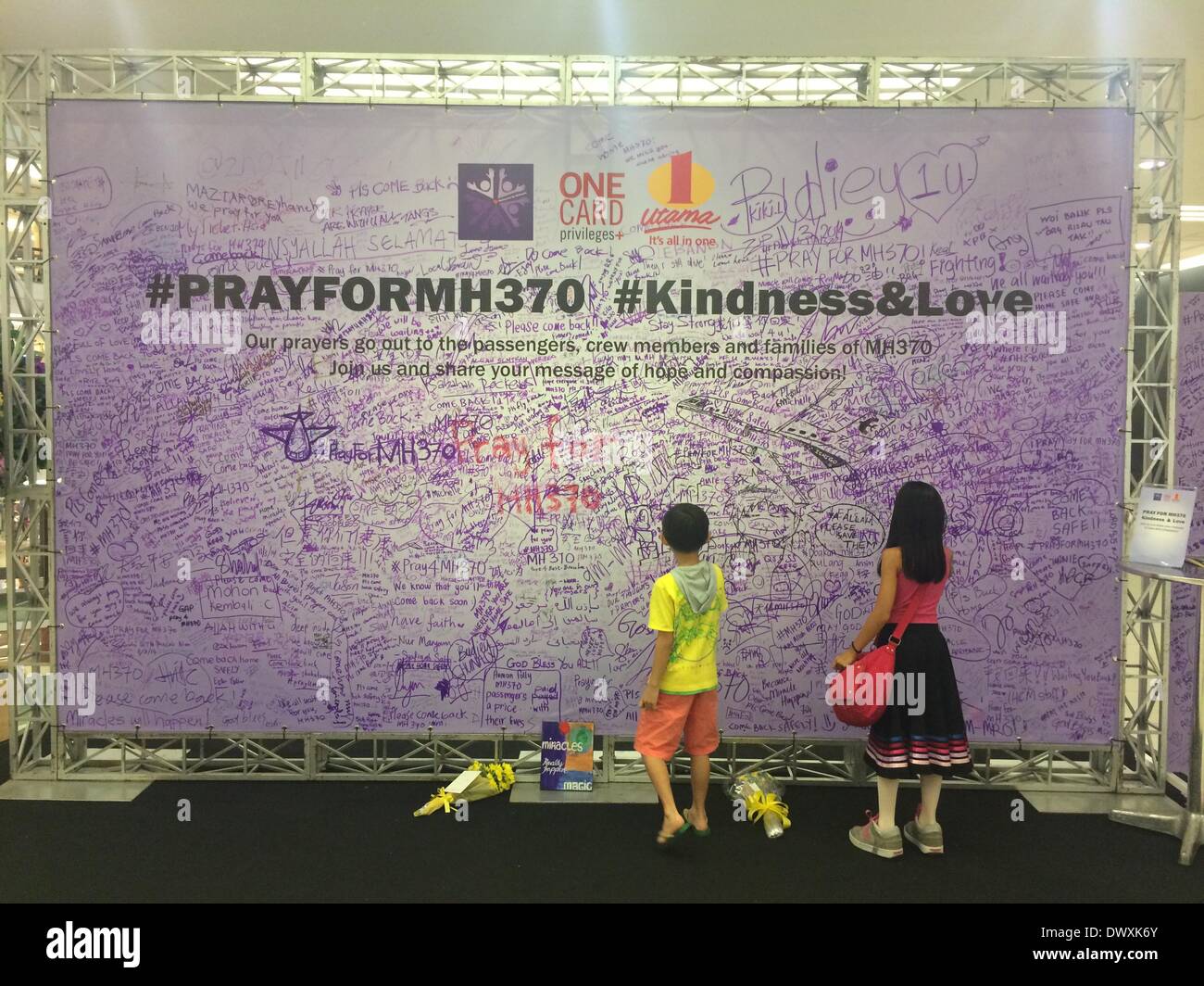 Kuala Lumpur, Malaysia 14 March, 2014: Two kids signing a billboard to Pray for the safe return of MAS MH370 Stock Photo