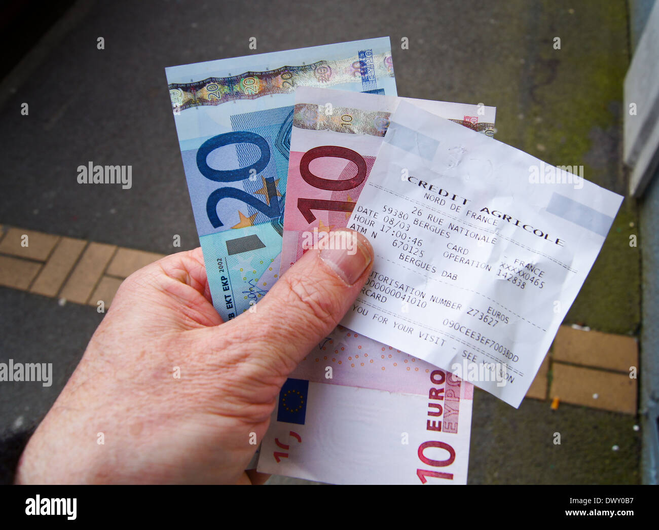 Closeup of a man's hand holding €30 euro withdrawn from a Credit Agricole cash machine in France Stock Photo