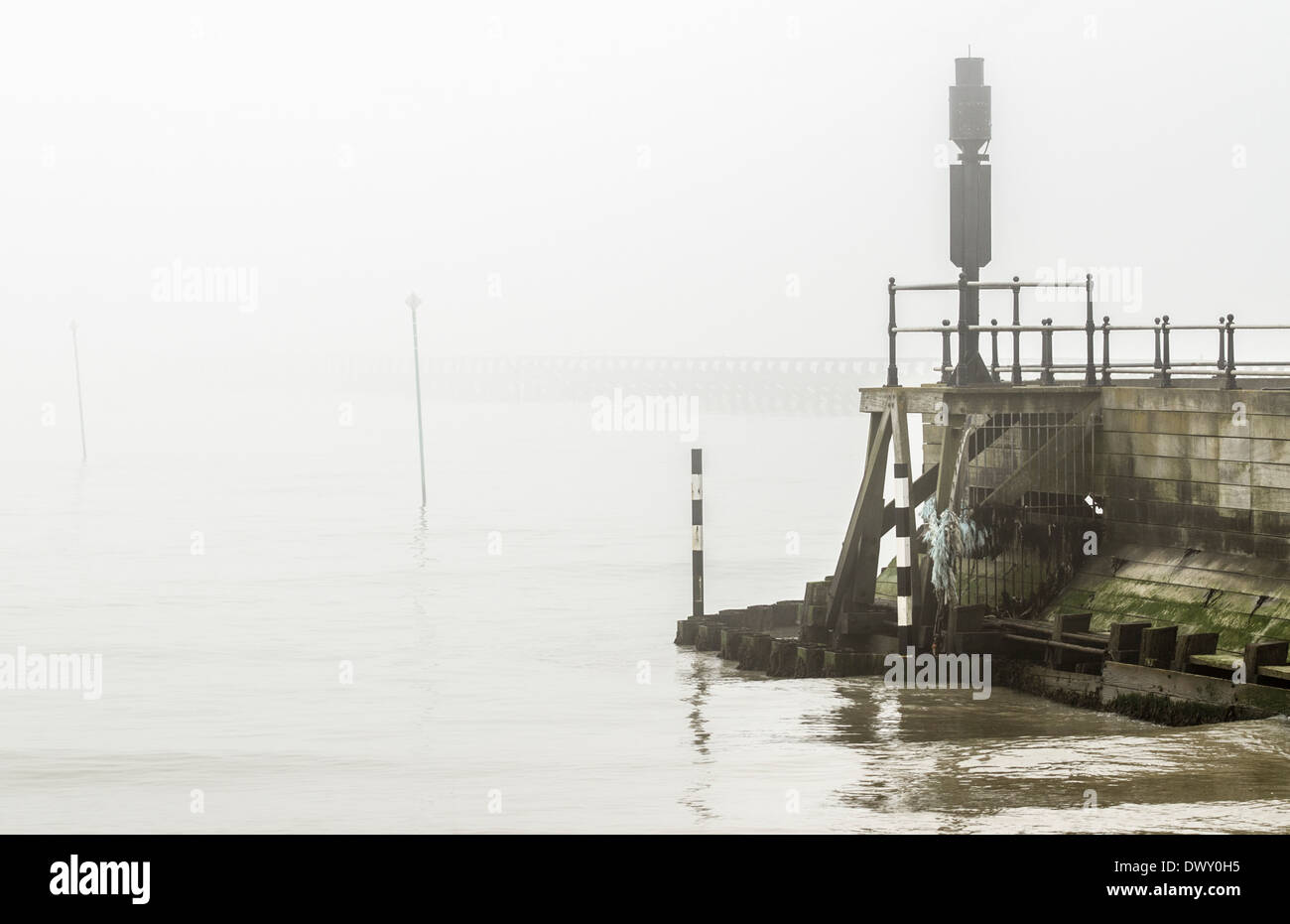 River estuary looking out to sea in foggy conditions. Stock Photo