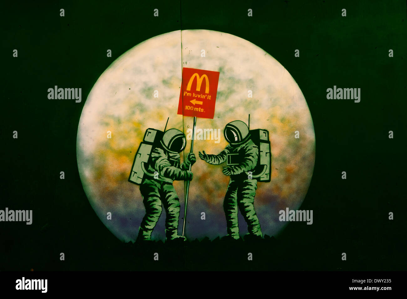 Banksy style graffiti of 2 men on the moon advertising McDonalds Stock Photo
