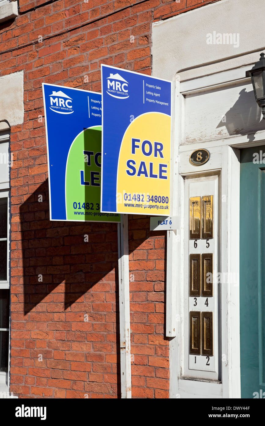 For sale and to let sign signs outside property house home flat flats Hull East Yorkshire England UK United Kingdom GB Great Britain Stock Photo