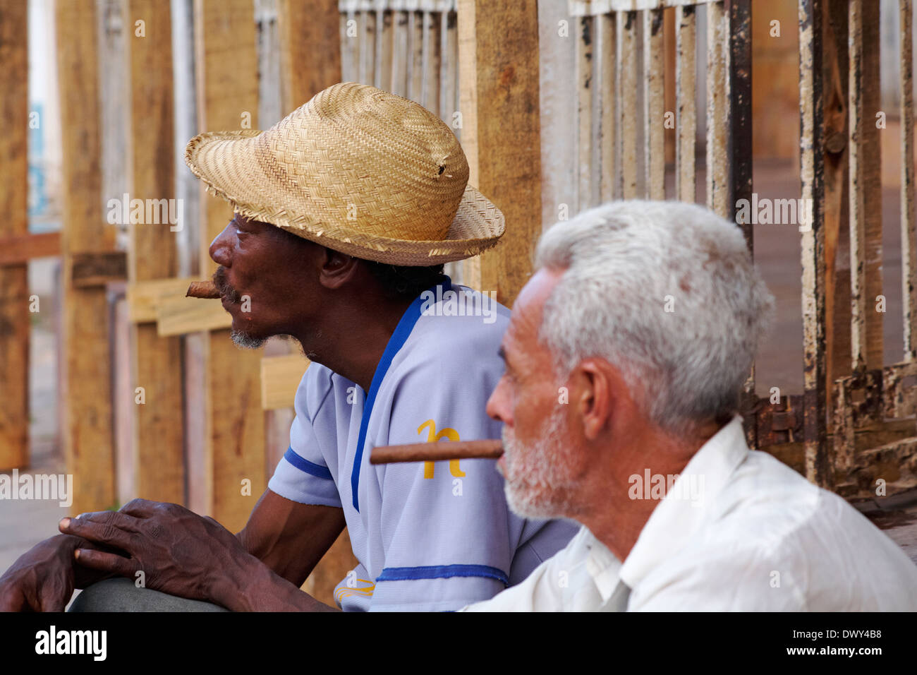 Daily life in Cuba - Men smoking cigars at Trinidad, Cuba, West Indies, Caribbean, Central America in March Stock Photo