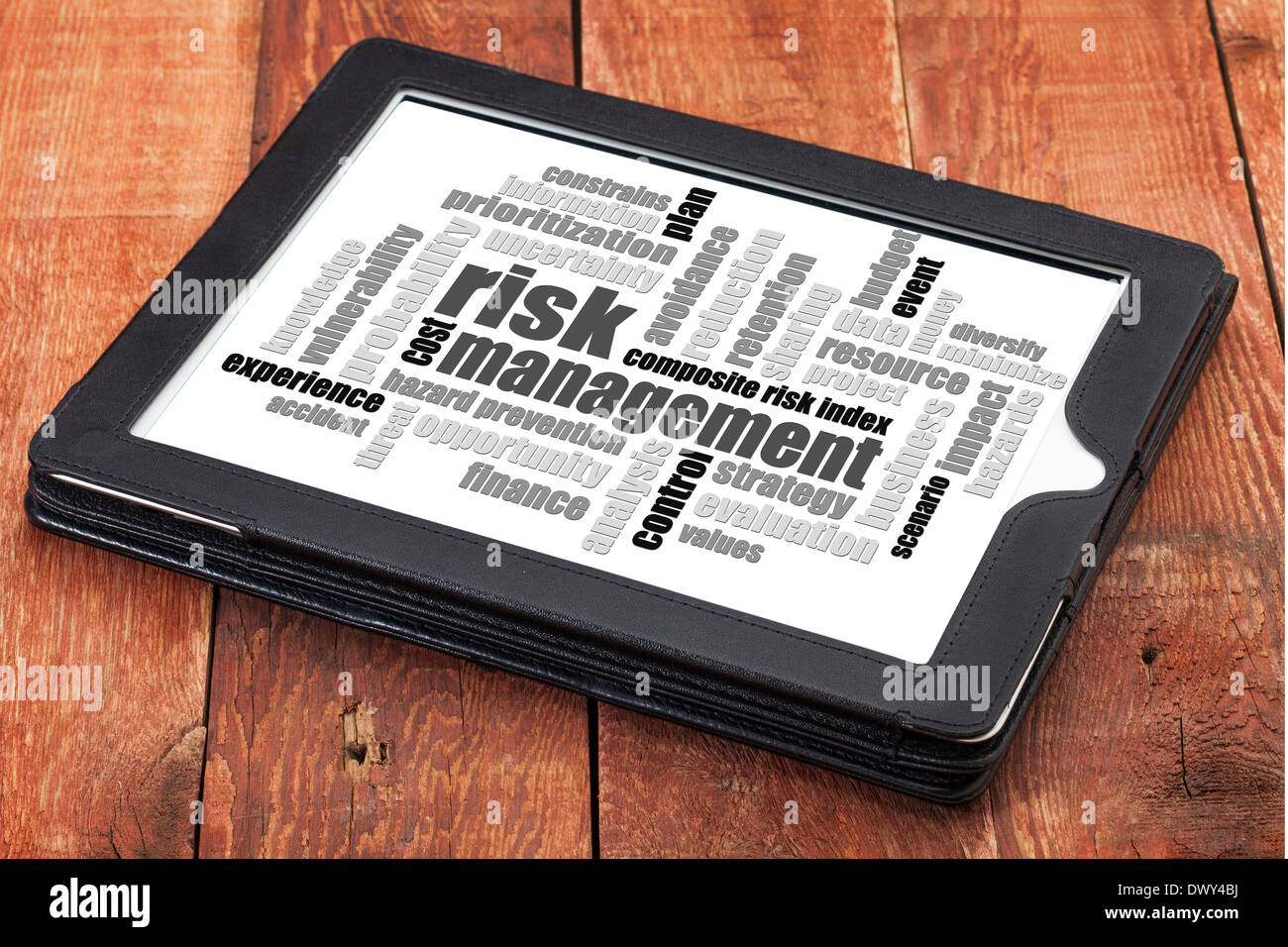 risk management word cloud - a digital tablet on a rustic wooden table Stock Photo