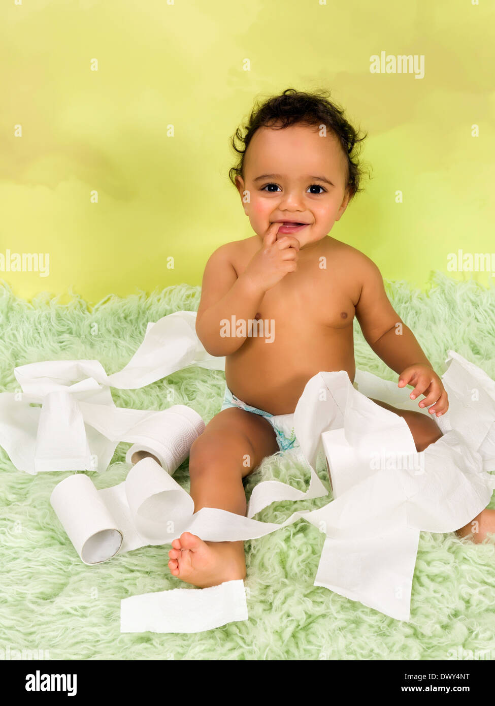 Adorable african baby boy playing with toilet paper Stock Photo