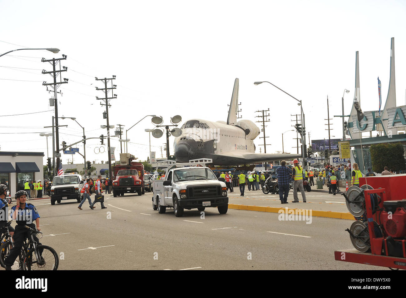 The Space Shuttle Endeavour is slowly transported through the streets ...