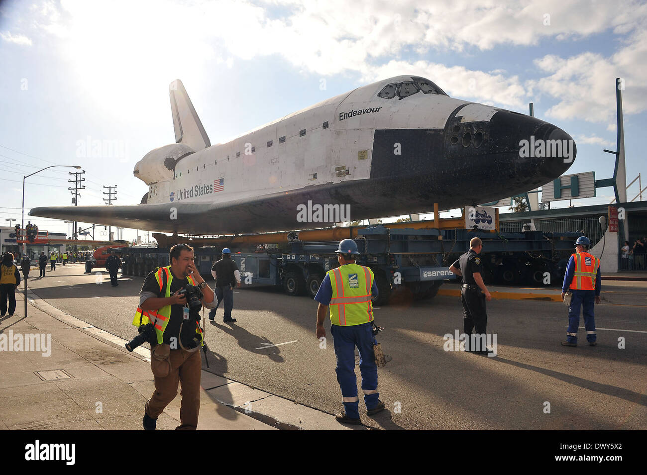 The Space Shuttle Endeavour is slowly transported through the streets ...