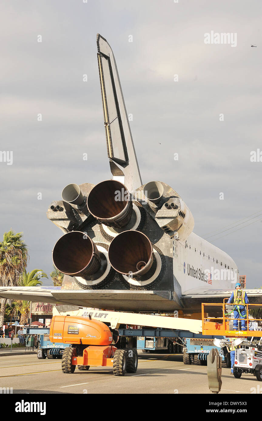 The Space Shuttle Endeavour is slowly transported through the streets ...