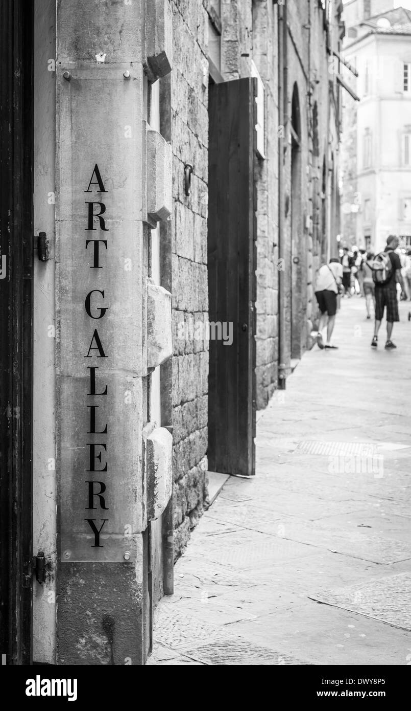 Tuscany, Italy. An art gallery signseen in a street full of turism. Stock Photo