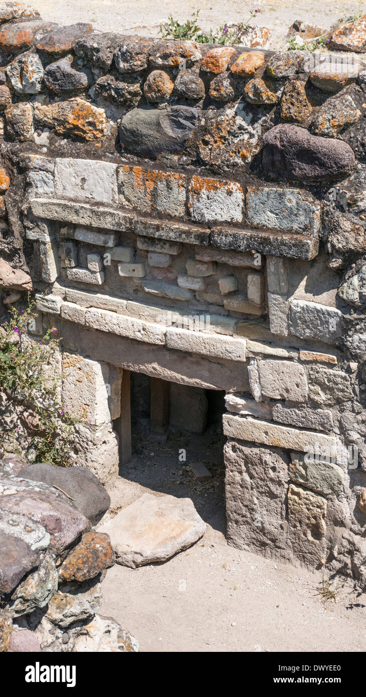sunken entrance to pre hispanic tomb with stone mosaic frieze above lintel in ruins of ancient city of Yagul Oaxaca State Stock Photo