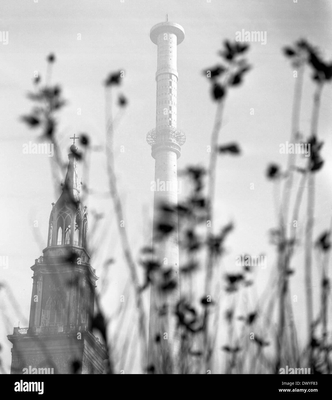 Berlin, GDR, Tower of St Mary's in front of the tower shaft of the television tower on Alexanderplatz Stock Photo