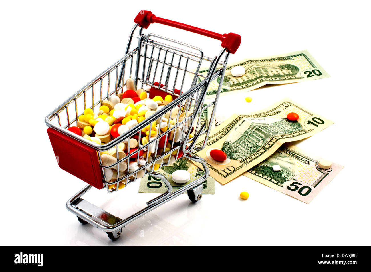 Drugs in the shopping cart on a white background. Money and pills nearby. Stock Photo