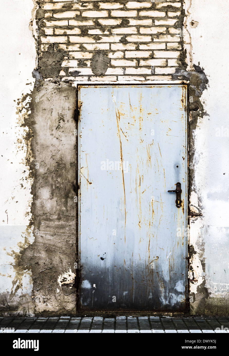 Ruined brick wall with closed steel door Stock Photo - Alamy