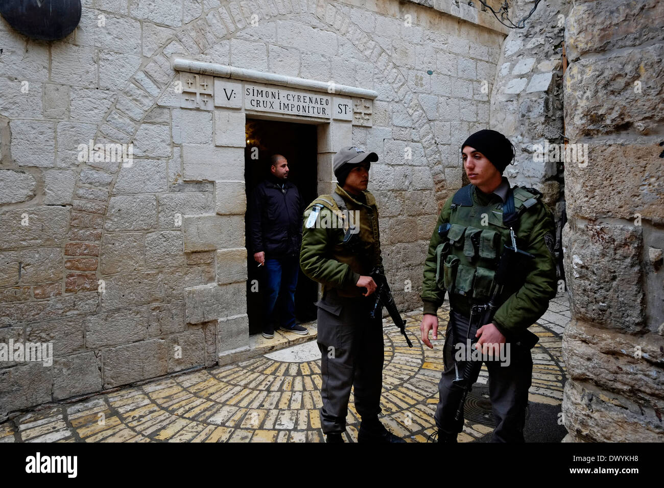 Members of the Israeli Security Forces stand guard next to the Chapel of Simon of Cyrene, at the 5th station of the cross in Via Dolorosa street believed to be the path that Jesus walked on the way to his crucifixion in the Old City. East Jerusalem, Israel Stock Photo
