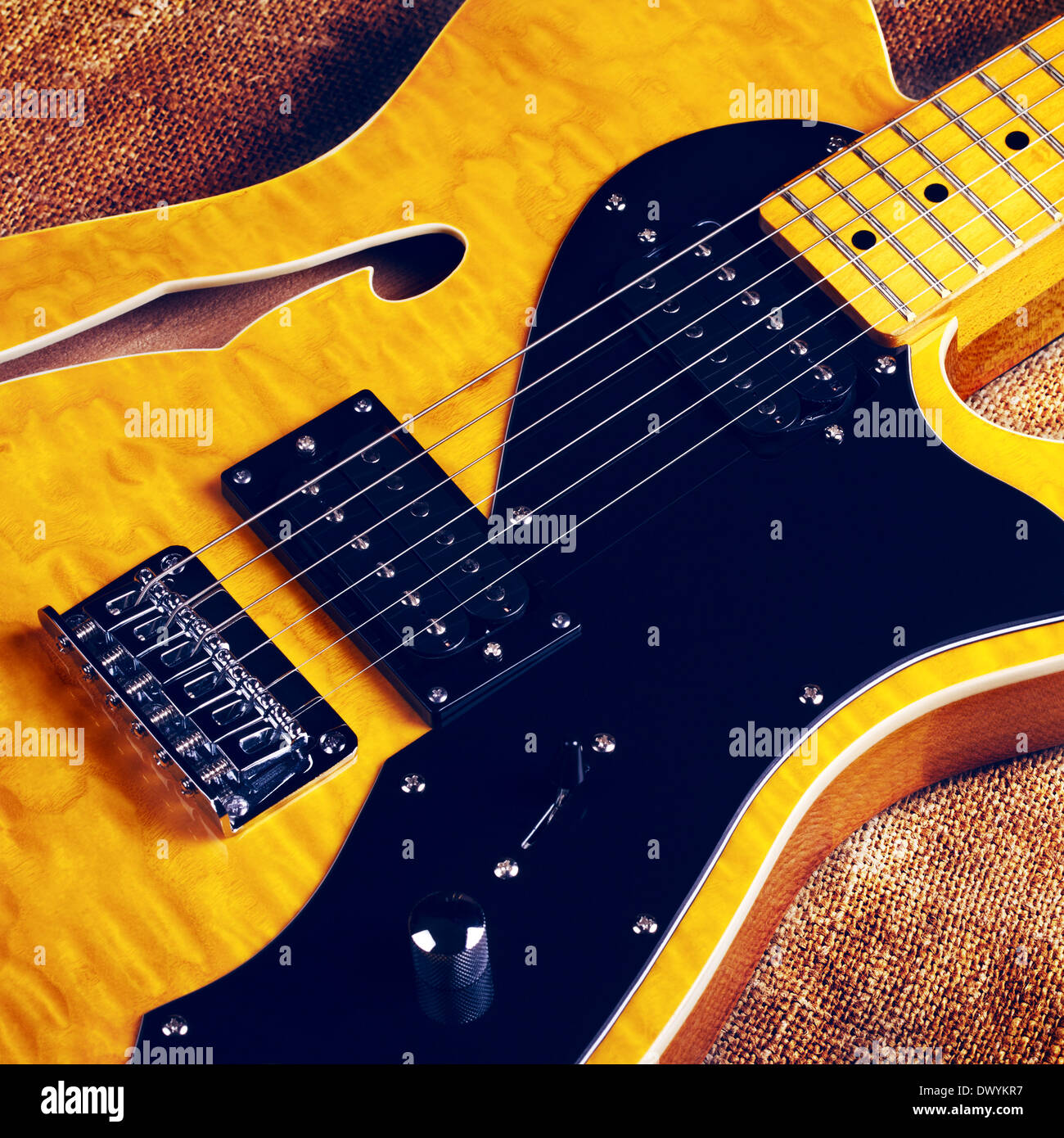 yellow semihollow electric guitar, on canvas background Stock Photo