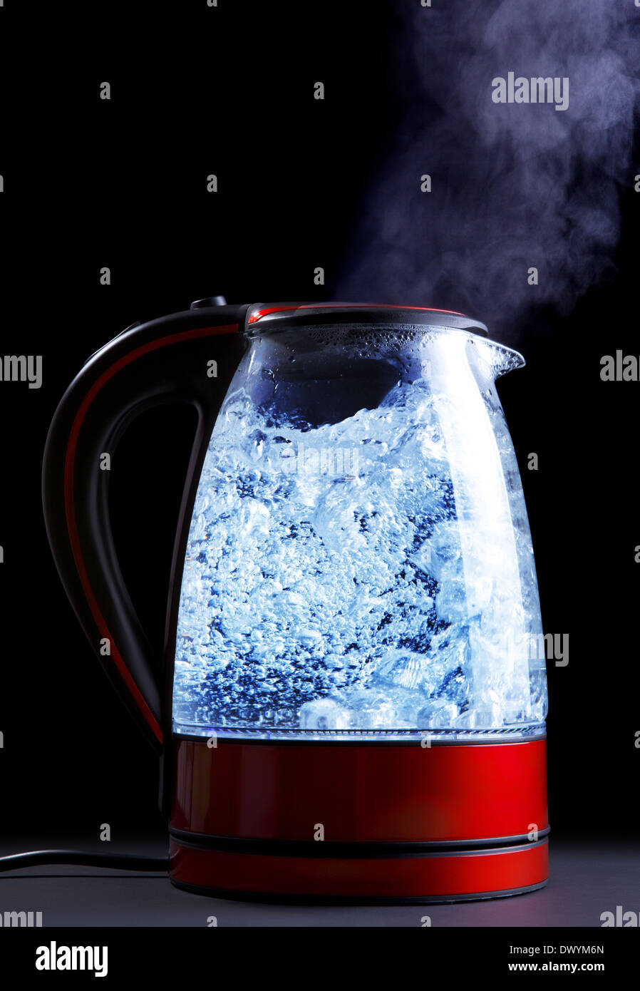 glass electric kettle with boiling water, black background Stock Photo