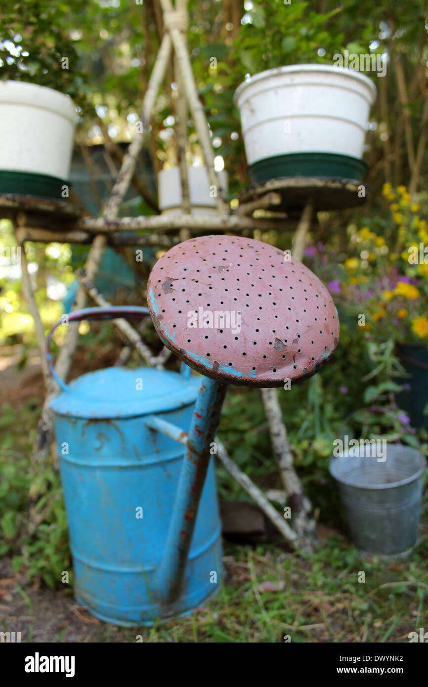 Antique watering can, bucket and flower rack illustrating garden work