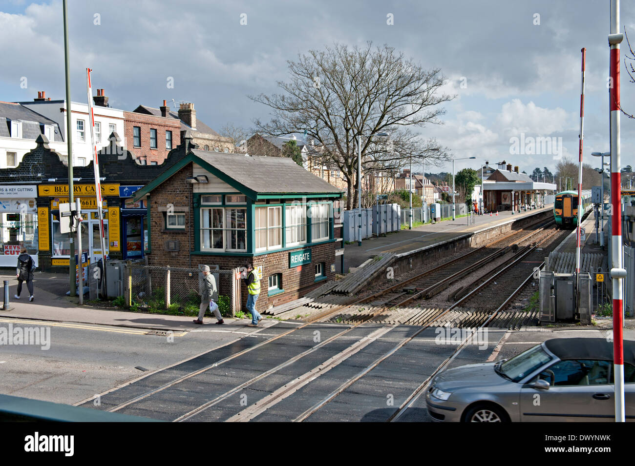 Reigate railway road crossing,  signalbox and station Surrey, UK Stock Photo