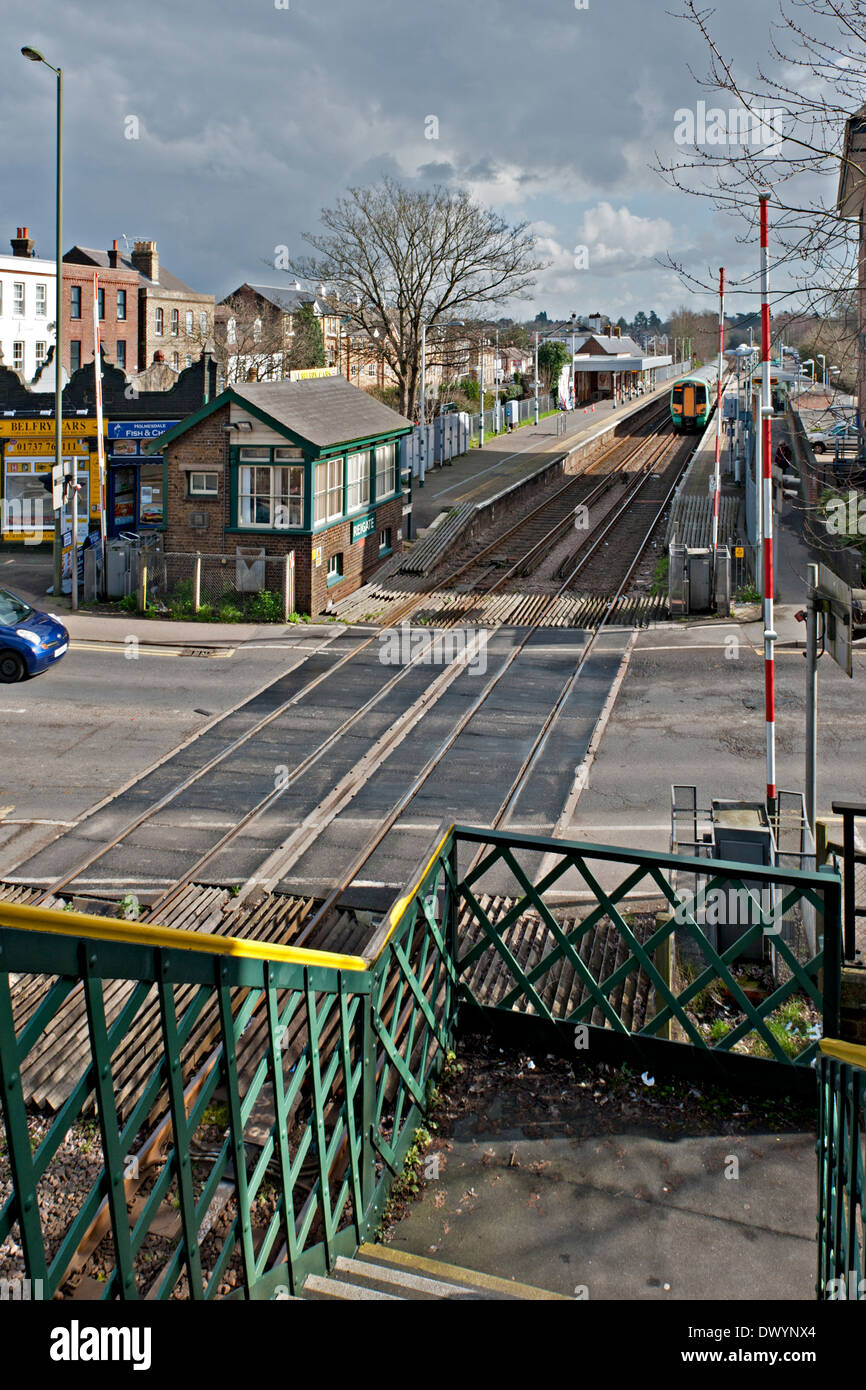 Reigate railway road crossing,  signalbox and station Surrey, UK Stock Photo
