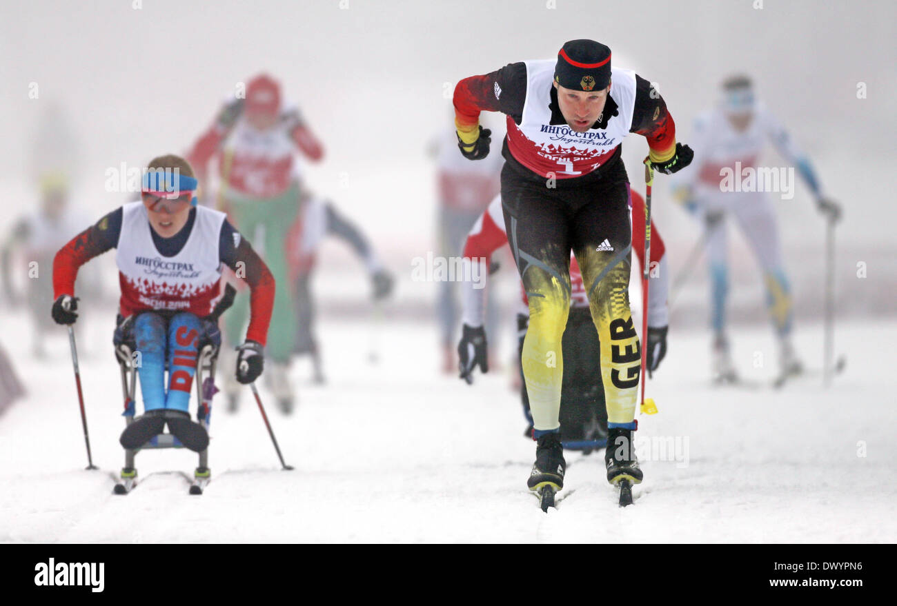 Tino Uhlig of Germany (r) and Svetlana Konovalova of Russia (l) compete in 4 x 2.5km Mixed Relay at the Cross-Country event at the Laura Cross-country Ski & Biathlon Center at the Sochi 2014 Paralympic Winter Games, Krasnaya Polyana, Russia, 15 March 2014. Photo: Jan Woitas/dpa Stock Photo