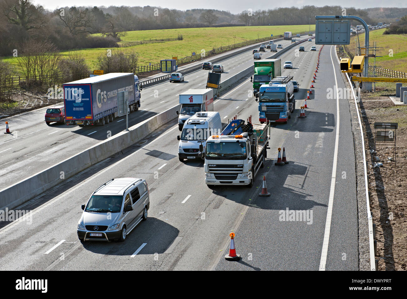 Traffic passing a coned off area on the M25 motorway in Surrey, UK Stock Photo