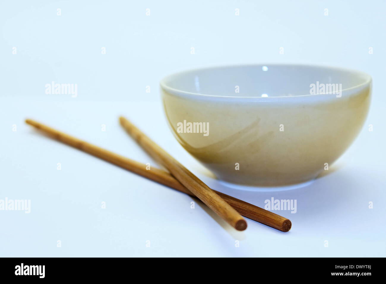 Chinese chopsticks on the board with bowl Stock Photo