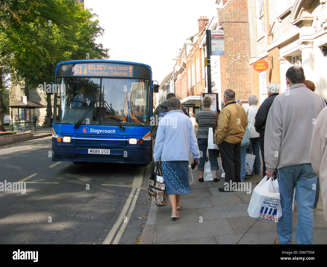 Bus stop queue of passengers city centre hires stock photography and
