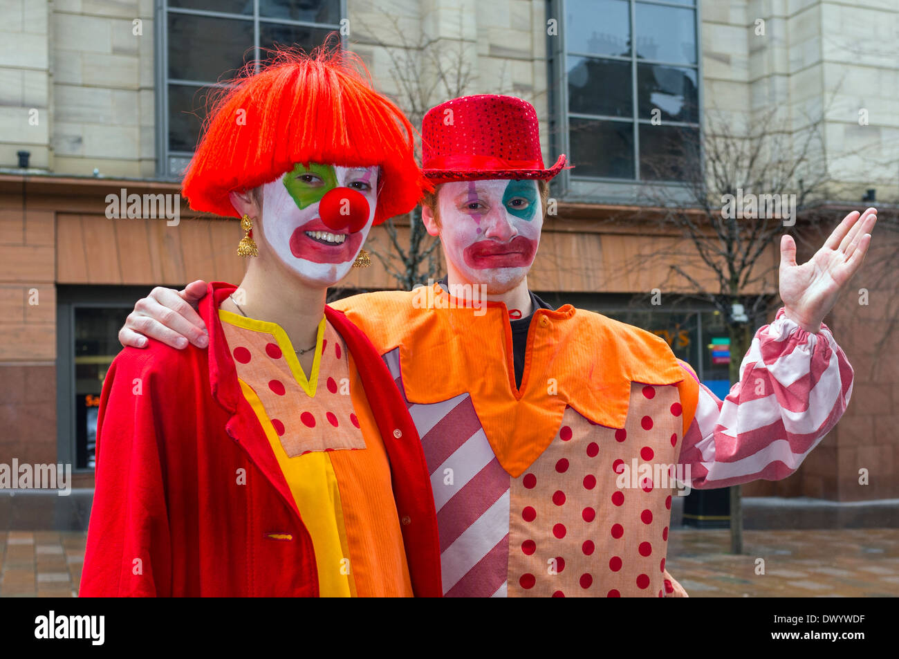 Two students from Glasgow RADA dressed as clowns who were performing and busking Stock Photo