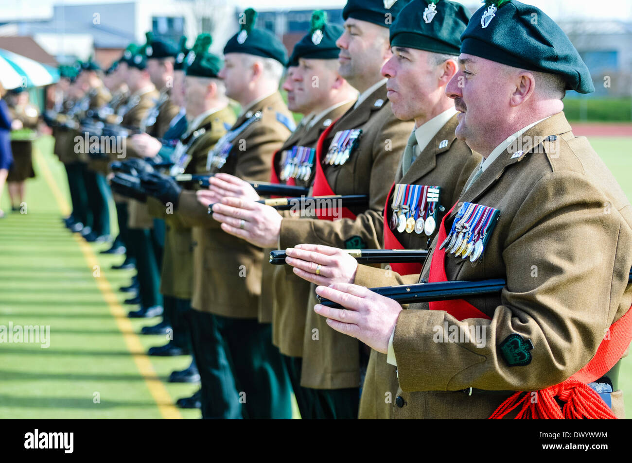 Lisburn, Northern Ireland. 15 Mar 2014 - Officers of the Royal Irish Regiment line up with their canes underneath their arms Credit:  Stephen Barnes/Alamy Live News Stock Photo