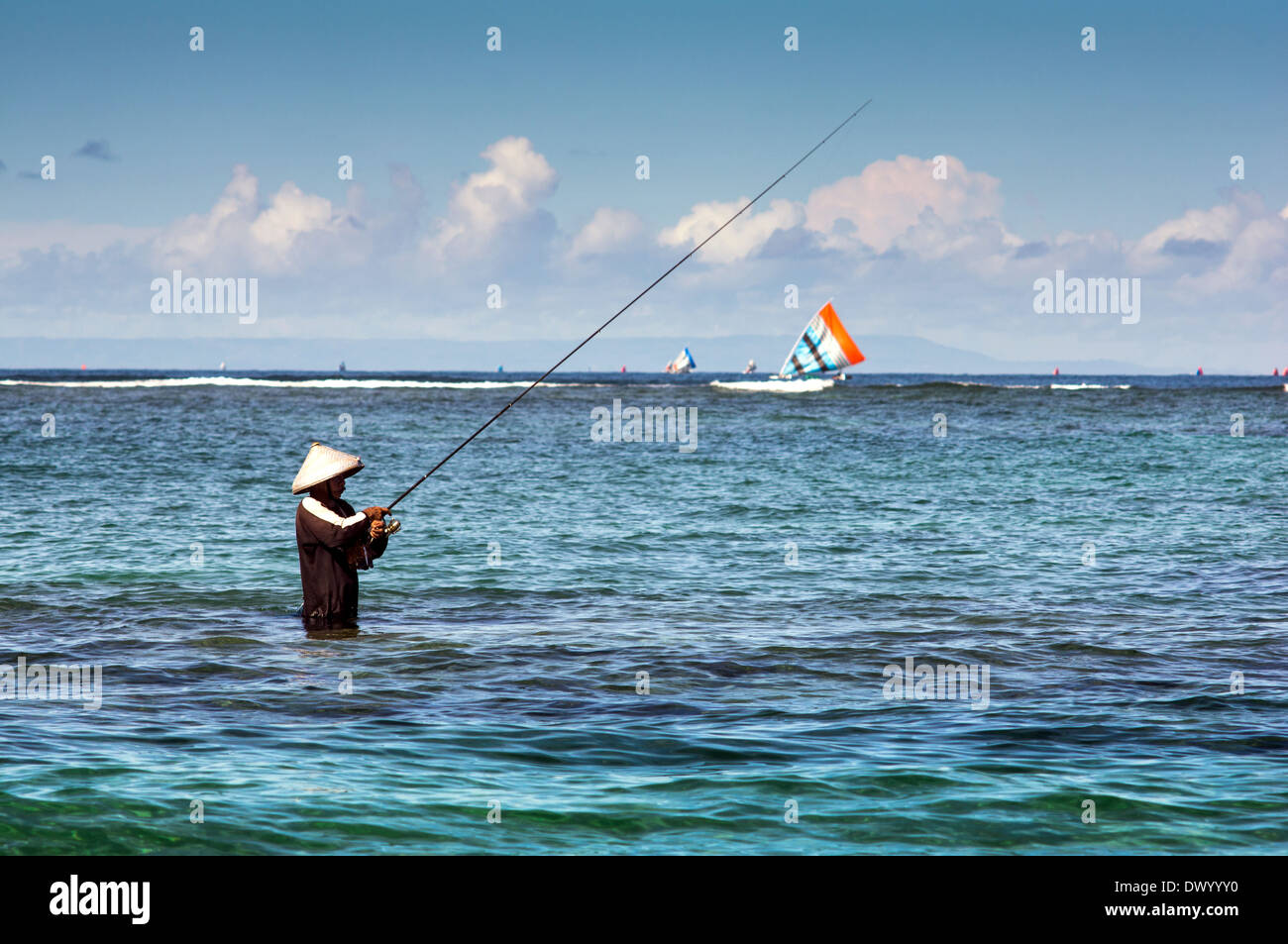 https://c8.alamy.com/comp/DWYYY0/local-fisherman-standing-in-the-sea-holding-a-fishing-rod-to-catch-DWYYY0.jpg