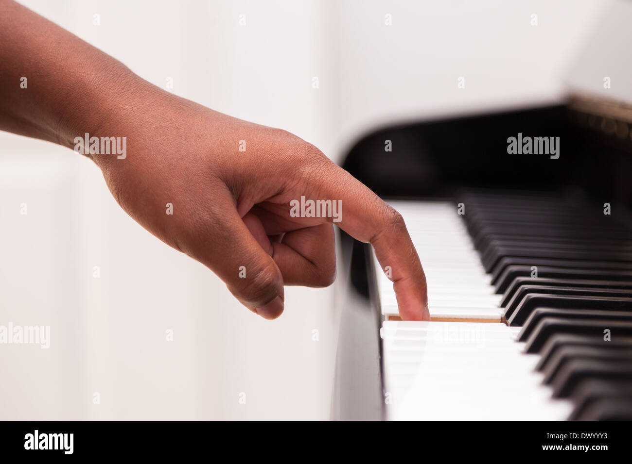 African American hand playing piano Touching piano keys Black