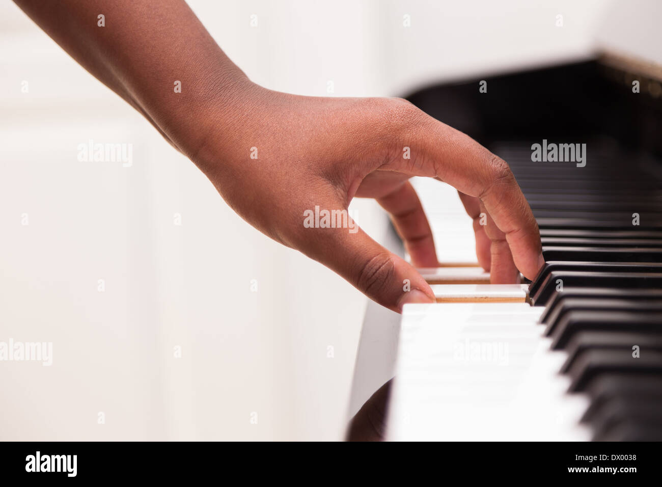 African American hand playing piano Touching piano keys Black