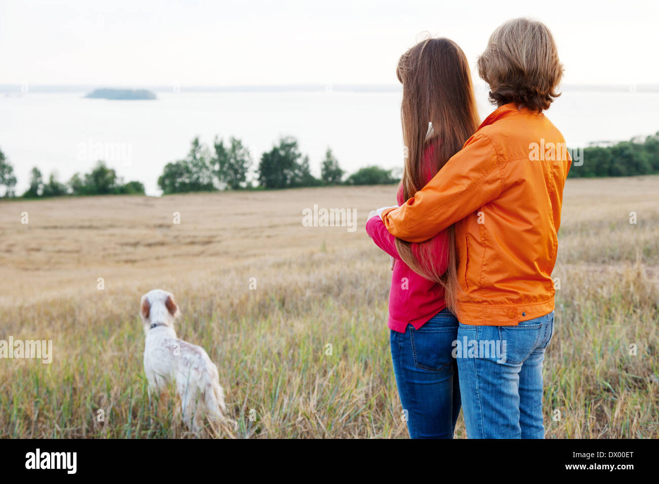 mother and her daughter with dog (Irish setter) outdoors Stock Photo