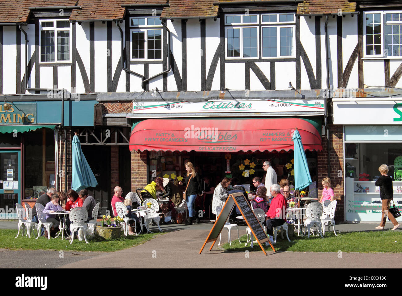 Shops and Edibles Delicatessen cafe on the High Street Banstead, Surrey, England. Stock Photo