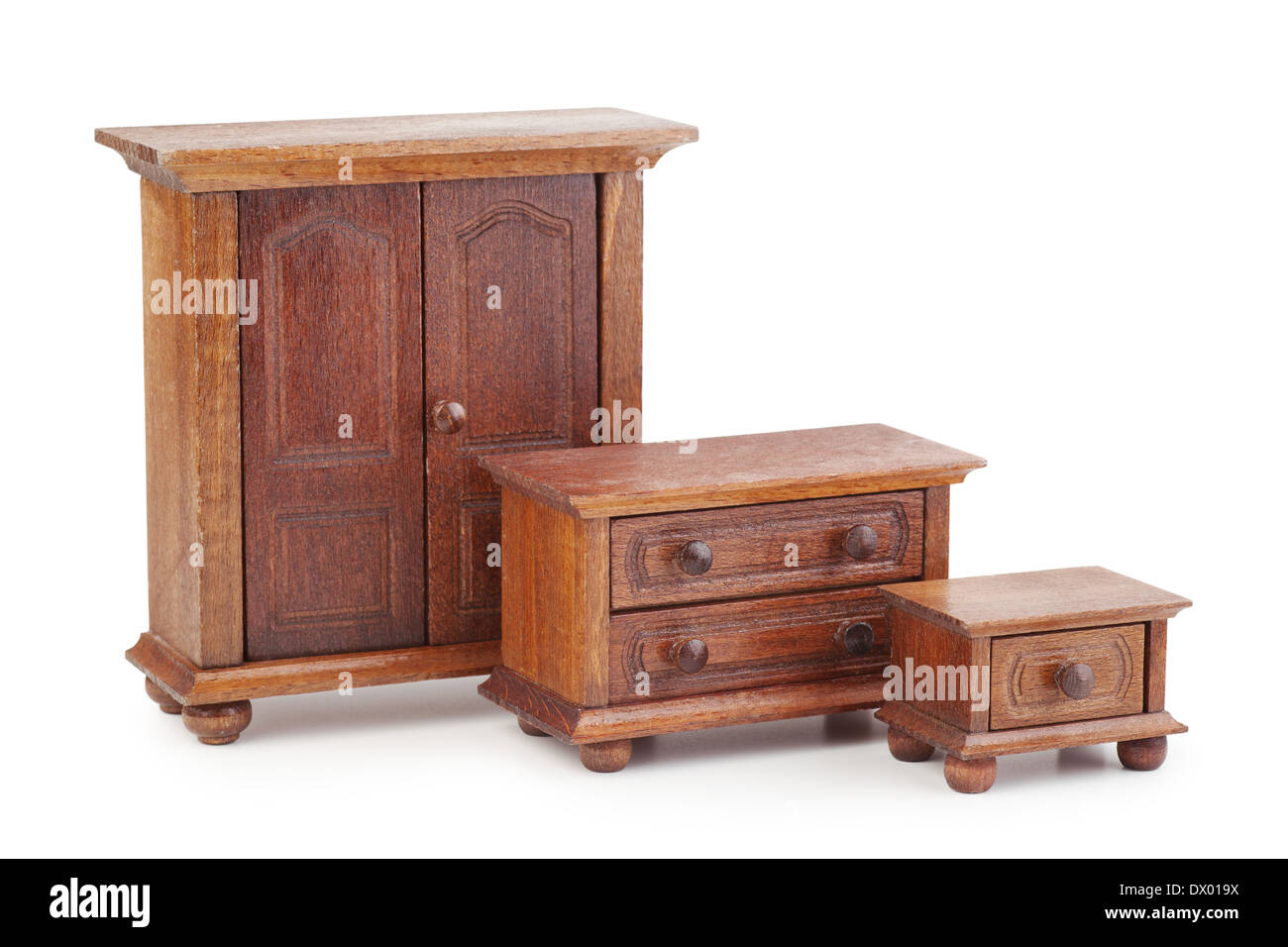 vintage doll wooden furniture set: wardrobe, chest of drawers and nightstand Stock Photo