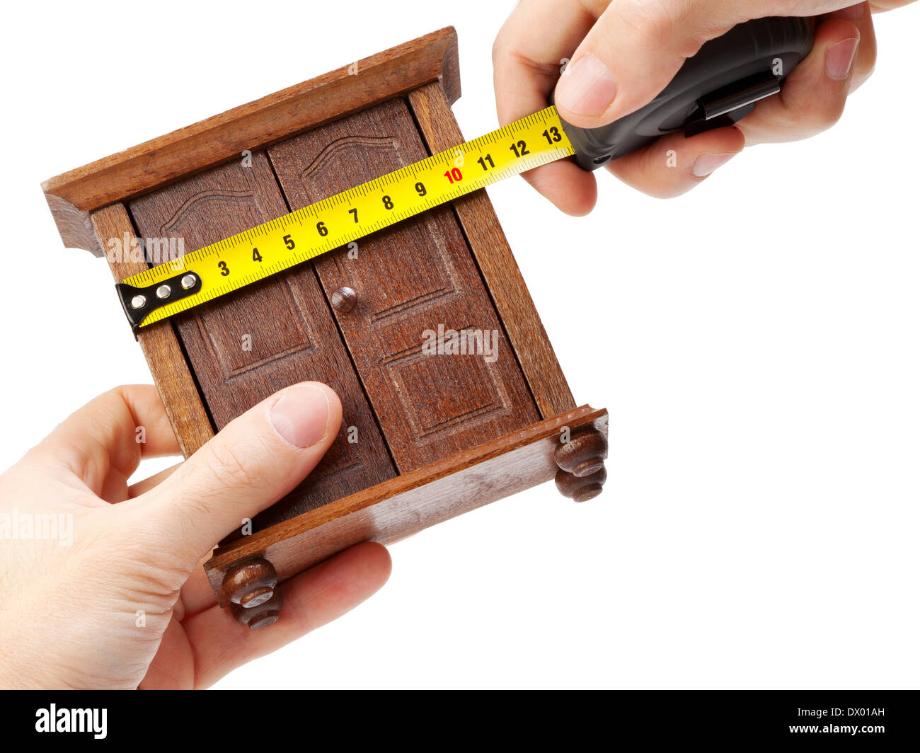 woodworker measuring wardrobe with a tape measure, carpentry concept Stock Photo